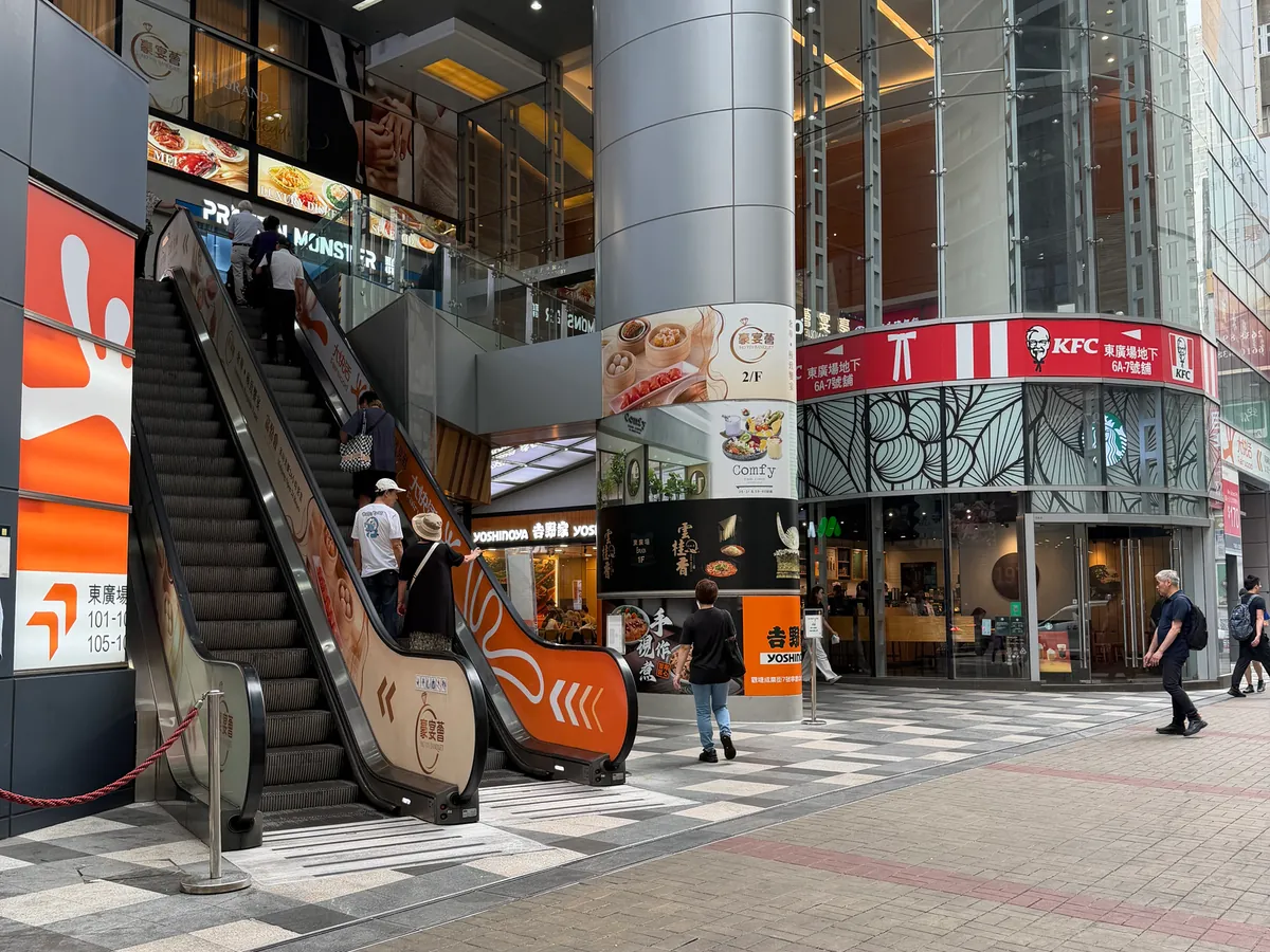 The E Plaza frontage at Legend Tower, with escalators on the left
