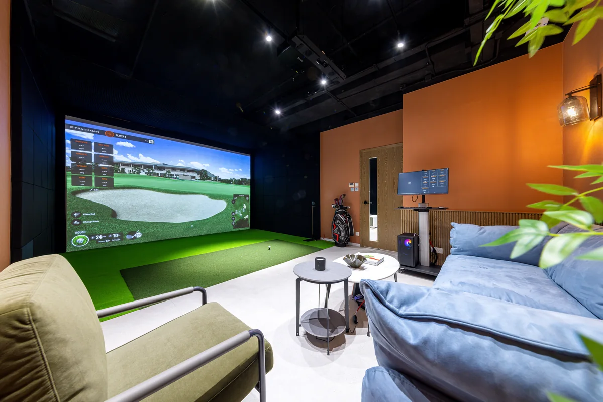 VIP Trackman room with simulator screen and lounge seating